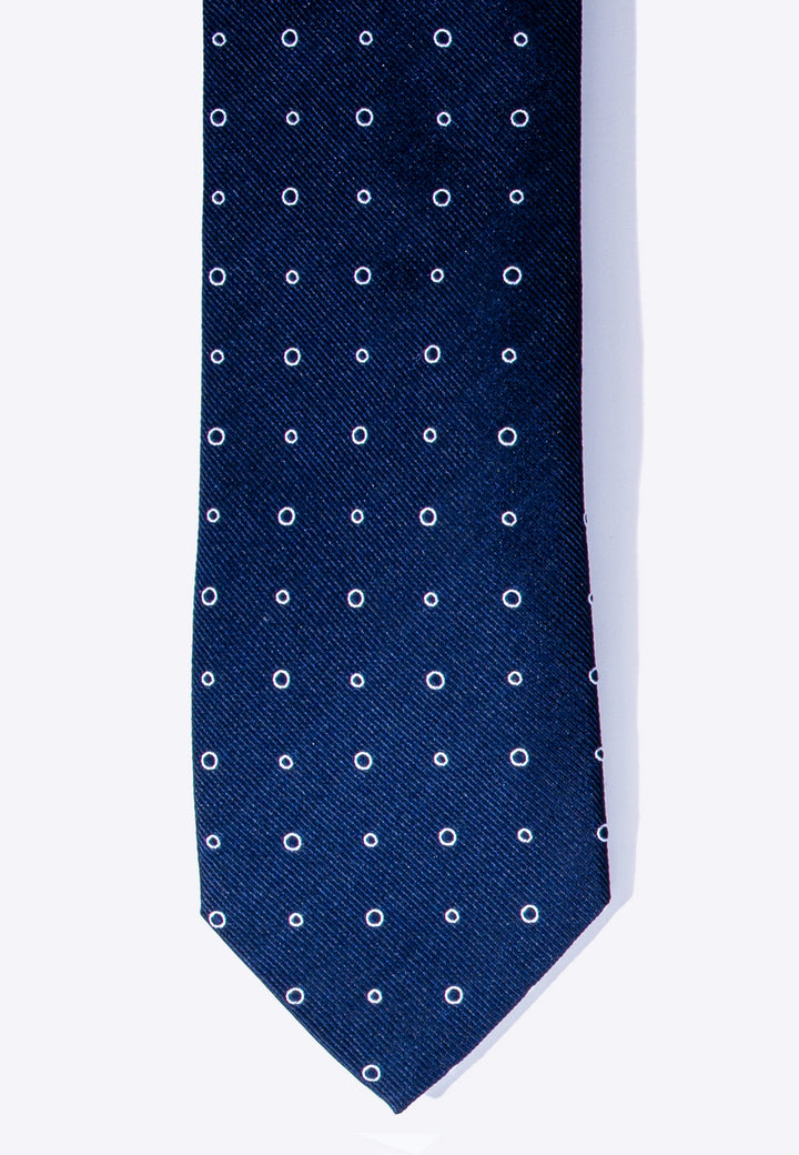 Cravatta uomo blu con fantasia ad anelli bianchi in pura seta